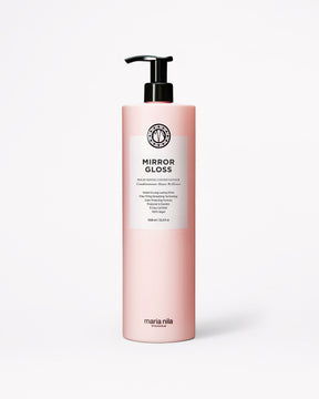A bottle of Maria Nila Mirror Gloss Conditioner in a pale pink bottle with a black pump and white label, centered on a light gray background.