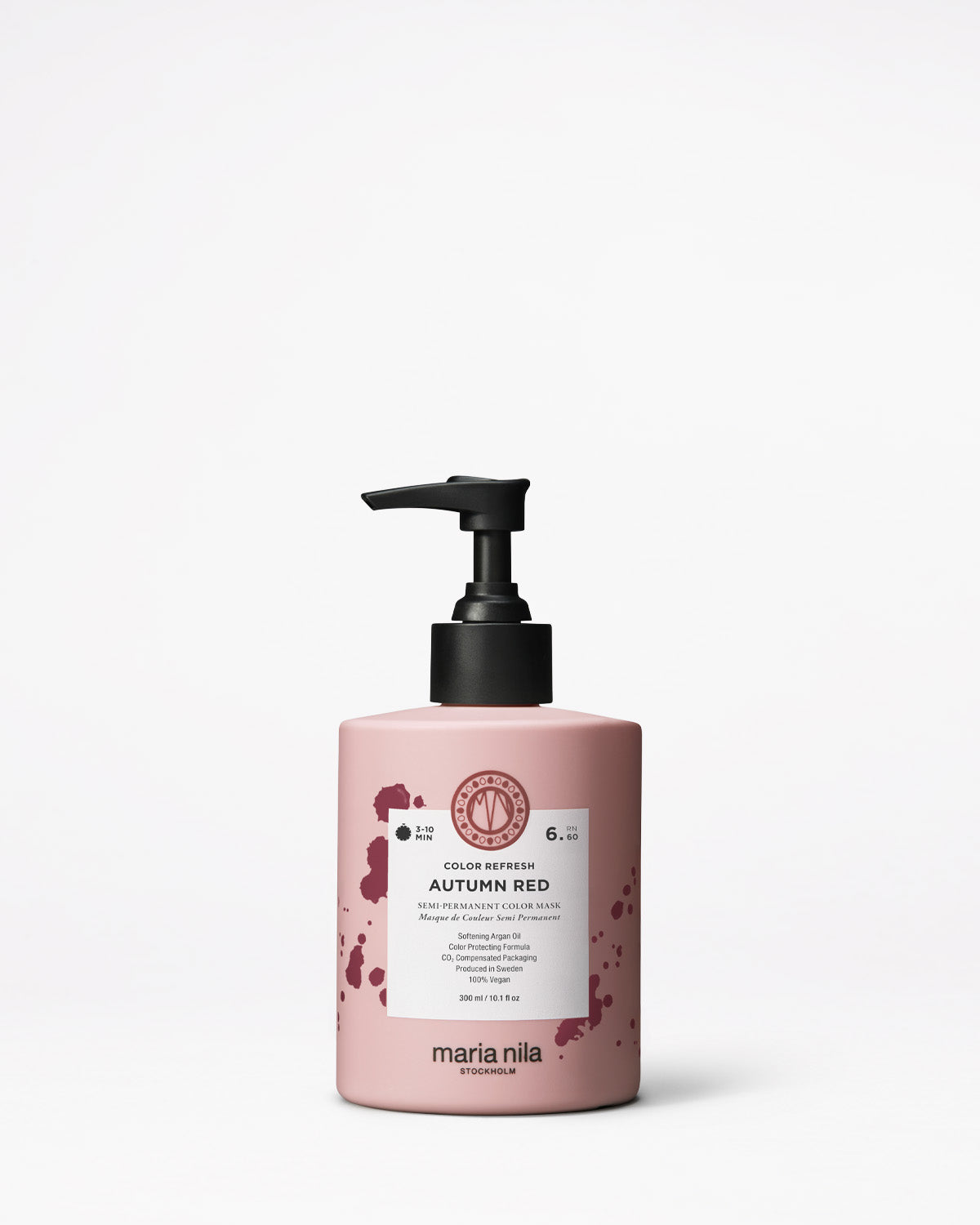 Pink hair care product bottle with black pump on a white background
