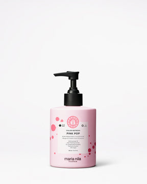 Pink hair color product bottle with black pump on a white background