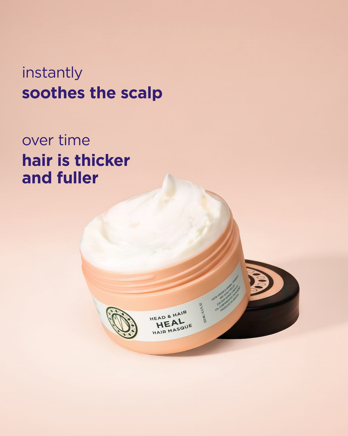 A jar of Heal Hair Masque hair mask with a white whipped cream texture, set against a soft peach-pink background with promotional text overlays.