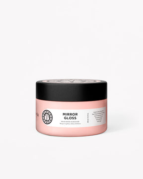 Pink jar with black lid labeled 'Mirror Gloss Mask' on a white background