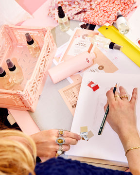 Person working on a project with stationery items on a desk